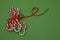 Pile Caramel sugar canes tied with a red ribbon on a green background. Christmas background. Concept of Christmas and New Year.