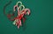 Pile Caramel sugar canes tied with a red ribbon on a green background. Christmas background. Concept of Christmas and New Year.