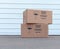 Pile of cardboard boxes over white warehouse door background
