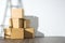 Pile of cardboard boxes on white background with Ladder shadow