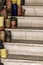 Pile of ceramic bowls of various sizes and colors on stairs