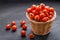 Pile of cherry tomatoes in a rattan basket