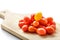 Pile of cherry tomatoes on a wooden cutting board