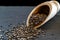 Pile chia flax seeds isolated on black food background. Healthy superfood in wooden spoon. Salvia hispanica antioxidant