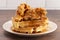 Pile of Chicken and Waffles on a Rustic Wooden Counter