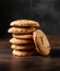 Pile of chocolate butter French biscuits on dark background.