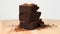 Pile of chocolate pieces with cocoa powder