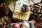 Pile of Christmas and New Year gift boxes wrapped in brown craft paper, pine cones, fir tree branches, baubles, wood ornaments