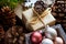 Pile of Christmas and New Year Gift Boxes Wrapped in Craft Paper Colorful Balls Big Pine Cones Green Fir Tree Branches Snow Flake