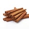 A pile of cinnamon sticks on a white background