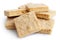 Pile of classic homemade square shortbread biscuits isolated on