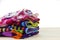 Pile of clothes colorful summer clothing on wood,white backgroun