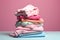 Pile of clothes ready for laundry. Stack of colorful clothes. Laundry day, fabric recycling concept. Fashion industry pollution,