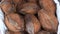 Pile of coconuts shell in the food market of India. bunch of brown coconut stacked together.