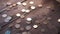 Pile of coins falling on the wooden table