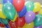 pile colorful balloons inflated with helium on a background