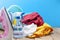 Pile of colorful clothes and irons,spray bottle on wooden plank ,blue color background