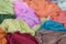 Pile of colorful clothes, textiles as a background