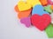 A pile of colorful hearts on a white background.