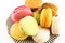 A Pile of Colorful Macaroons on a Plate on White Background