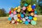 Pile of colorful painted tree trunks outside