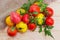 Pile of the colorful tomatoes with twigs and leaves