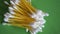 A pile of cotton swabs on a green surface, close-up video. Lots of cotton buds.