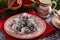 Pile of cracked chocolate cookies on old english style plate, Christmas decoration on background
