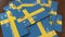 Pile of credit cards with flag of Sweden. Swedish banking system conceptual 3D animation