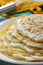 Pile of crepes with cottage cheese and grated coconut