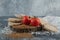 Pile of crispbread, tomatoes and raw buckwheat on wooden piece