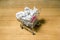 A pile of crumpled paper in a miniature grocery cart
