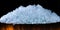 Pile of crushed ice cubes in wood bucket on dark background with copy space. Crushed ice cubes foreground for beverages, beer