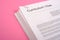 Pile of cv on pink background as equal opportunities concept