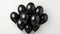 Pile of deflated black balloons on a white background.