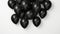 Pile of deflated black balloons on a white background.