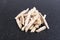 Pile of dehydrated taro snack sticks isolated over black