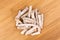 Pile of dehydrated taro snack sticks isolated over wood top down view