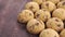 Pile of delicious chocolate chip cookies. Round small biscuits on a wooden surface