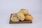 Pile of delicious Paraguayan chipa bread on a wooden tray with an isolated background
