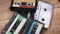 Pile of Different Audio Cassettes Rotates on a Wooden Table Close-Up