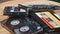 Pile of Different Audio Cassettes Rotates on a Wooden Table Close-Up