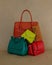 Pile of different trendy luxury coloured leather handbags. art. advertising