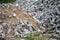 Pile of disassembled gray pavement bricks with selective focus