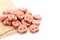 Pile of dog food pink cookie grilled beef taste isolated on white