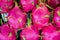 Pile of dragon fruit background. Pile of tropical dragon fruit or pitaya for sale at local farmer`s market.