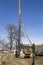 Pile driving machine against the blue sky on the edge of the pit