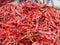 Pile of dry chilies on bamboo basket for sale in the market