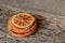 A pile of dry sliced Orange tied with a gray thread on a wooden table