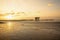 Pile dwellings at North Sea beach in sunset